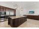 Spacious kitchen with stainless steel appliances, a large island, and seamless access to the living area at 225 Magnolia St, Windermere, FL 34786
