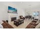 Inviting living room with a fireplace, comfortable seating, and a view of the water at 225 Magnolia St, Windermere, FL 34786