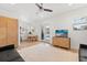 Bright living area with a modern television, ceiling fan, and door leading to a patio area at 225 Magnolia St, Windermere, FL 34786