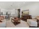 Second floor living room featuring hardwood floors, a stylish accent rug, and an adjacent glass elevator at 225 Magnolia St, Windermere, FL 34786