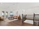 Cozy living room with hardwood floors, a comfortable sofa, and plenty of natural light at 225 Magnolia St, Windermere, FL 34786
