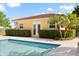 View of pool house in this backyard including part of pool with tiled accents at 225 Magnolia St, Windermere, FL 34786
