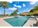 Beautiful backyard swimming pool and outdoor spa surrounded by white tile deck at 225 Magnolia St, Windermere, FL 34786
