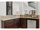 Wet bar area with granite countertop, dark wood cabinets, and beverage fridge at 225 Magnolia St, Windermere, FL 34786