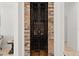 Custom wine cellar with brick accent and secure iron gate at 225 Magnolia St, Windermere, FL 34786
