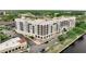 Stunning aerial view of a waterfront condominium building with elegant architecture and ample parking at 225 W Seminole Blvd # 409, Sanford, FL 32771