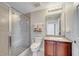 Bathroom featuring glass shower, granite vanity, and neutral tile at 225 W Seminole Blvd # 409, Sanford, FL 32771