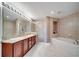 Elegant bathroom with double vanity, soaking tub, walk-in shower, and marble flooring at 225 W Seminole Blvd # 409, Sanford, FL 32771