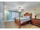 Bedroom features wood floors, ceiling fan, window with blinds and a classic wood bed frame at 225 W Seminole Blvd # 409, Sanford, FL 32771