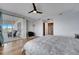 Bright bedroom features hardwood floors, ceiling fan and sliding door to a private balcony with seating at 225 W Seminole Blvd # 409, Sanford, FL 32771