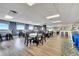 Community dining area features multiple tables, chairs, and a servery with comfortable barstool seating at 225 W Seminole Blvd # 409, Sanford, FL 32771