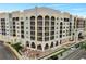 An aerial view of a colorful, multi-story building featuring pools and balconies at 225 W Seminole Blvd # 409, Sanford, FL 32771
