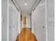 Hallway with multiple storage closets and hardwood flooring at 225 W Seminole Blvd # 409, Sanford, FL 32771