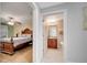 Hallway with access to bedroom and bathroom features tile flooring and neutral paint at 225 W Seminole Blvd # 409, Sanford, FL 32771