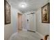 Inviting hallway featuring white tile floors, elegant artwork, and a well-lit, welcoming atmosphere at 225 W Seminole Blvd # 409, Sanford, FL 32771