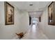 Bright hallway featuring tile floors, decorative art, and stylish accents leading to living areas at 225 W Seminole Blvd # 409, Sanford, FL 32771