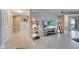 Bright open-concept living area with tile floors, modern decor, and access to a balcony with scenic views at 225 W Seminole Blvd # 409, Sanford, FL 32771