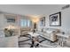 Cozy living room with comfortable seating, stylish decor, and abundant natural light from the window at 225 W Seminole Blvd # 409, Sanford, FL 32771