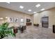 Bright lobby area with travertine flooring, comfortable seating, contemporary artwork and an elevator at 225 W Seminole Blvd # 409, Sanford, FL 32771