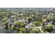 An aerial shot showcases a beautiful neighborhood with waterfront homes and lush greenery at 2601 Windward Ct, Orlando, FL 32805