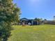 Expansive backyard featuring lush green lawn, a patio and mature trees, creating a private outdoor space at 2601 Windward Ct, Orlando, FL 32805