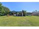 Lush backyard with expansive lawn, patio, and mature trees offering privacy at 2601 Windward Ct, Orlando, FL 32805