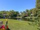 Backyard view with canal access, lush greenery and dock at 2601 Windward Ct, Orlando, FL 32805