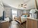 Cozy bedroom with wood floors, ceiling fan, and a window for natural light at 2601 Windward Ct, Orlando, FL 32805