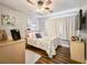 Light and airy bedroom with neutral walls, wood floors, ceiling fan, and natural light at 2601 Windward Ct, Orlando, FL 32805