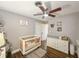 Bedroom with a crib, wood floors, ceiling fan, and natural light at 2601 Windward Ct, Orlando, FL 32805