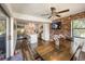 Dining room featuring wood floors, brick wall, ceiling fan, and adjoining kitchen with stainless steel appliances at 2601 Windward Ct, Orlando, FL 32805
