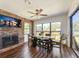Inviting dining room features a fireplace, wood floors, ceiling fan, and outdoor views at 2601 Windward Ct, Orlando, FL 32805