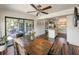 Open dining room and kitchen area with wood floors, access to the screened-in porch, and stainless refrigerator at 2601 Windward Ct, Orlando, FL 32805