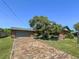 Beautiful brick home with a brick driveway, a two-car garage and lush landscaping at 2601 Windward Ct, Orlando, FL 32805
