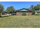 Charming brick home with a well-manicured lawn and beautiful landscaping enhancing its curb appeal at 2601 Windward Ct, Orlando, FL 32805