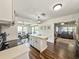 Kitchen with modern cabinets, island with white countertop, and views into dining and living rooms at 2601 Windward Ct, Orlando, FL 32805