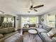 Bright and airy living room with hardwood floors and oversized windows with view of canal at 2601 Windward Ct, Orlando, FL 32805