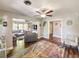 Comfortable living room with wood floors, ceiling fan, and multiple seating arrangements at 2601 Windward Ct, Orlando, FL 32805