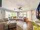 Bright living room features a large sectional sofa, wood floors, and lots of natural light at 2601 Windward Ct, Orlando, FL 32805