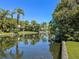 Scenic view of the tranquil canal, enhanced by lush greenery and swaying palm trees at 2601 Windward Ct, Orlando, FL 32805