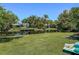 Waterfront back view of the home on a canal, with dock, grass lawn and mature landscaping at 2601 Windward Ct, Orlando, FL 32805