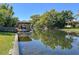 Scenic waterfront view with private dock and boatlift providing direct access to the canal at 2601 Windward Ct, Orlando, FL 32805