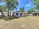 Expansive backyard with a brick fire pit and view of the home at 2617 S Marshall Ave, Sanford, FL 32773