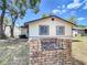 Backyard featuring a brick fire pit and partial view of the home's exterior at 2617 S Marshall Ave, Sanford, FL 32773