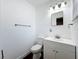 Bright bathroom features a white vanity, toilet, mirror, and modern lighting at 2617 S Marshall Ave, Sanford, FL 32773