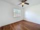 A bedroom with wood-look flooring, neutral walls, and a window at 2617 S Marshall Ave, Sanford, FL 32773