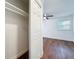 A bedroom with a view of the closet, plus wood-look floors, and a ceiling fan at 2617 S Marshall Ave, Sanford, FL 32773