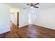 Bright bedroom boasts sleek wood floors, a ceiling fan, and ample closet space at 2617 S Marshall Ave, Sanford, FL 32773