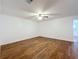 Bright bedroom featuring wood-look vinyl floors, a ceiling fan, and neutral walls with white trim at 2617 S Marshall Ave, Sanford, FL 32773