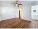 Spacious bedroom has wood floors, ceiling fan, closet, and an attached bathroom at 2617 S Marshall Ave, Sanford, FL 32773